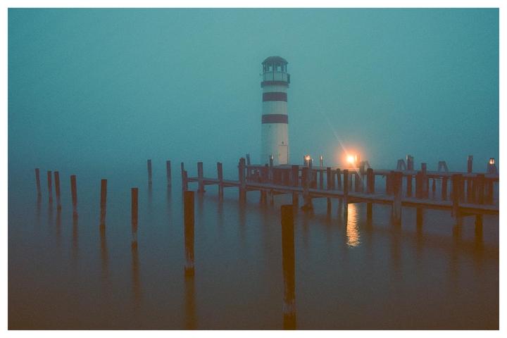 Lighthouse at a lonely pier during a foggy evening [Nikon F100, Ektar 100]