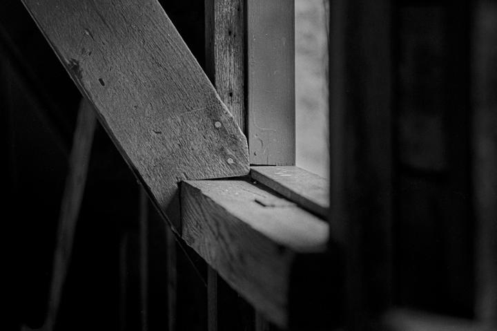 A close-up view of wooden beams and planks forming part of a structure.