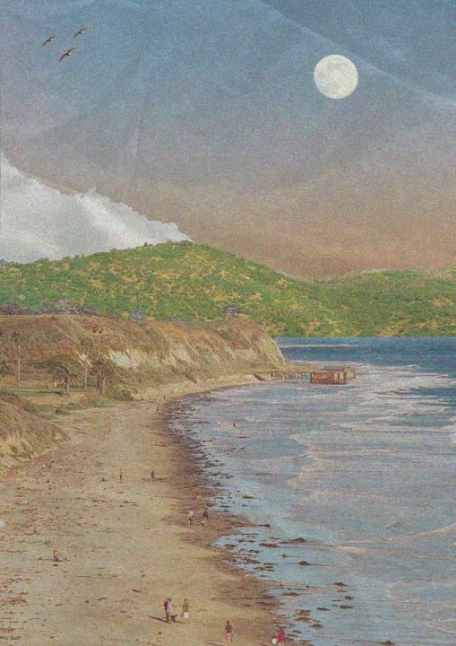 A full moon hangs in the sky over a beach with people and a dog, with hills and a pier in the distance.