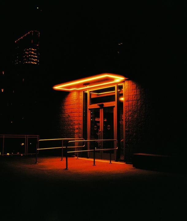 Door with cool light at night shot on Harman Red // Mamiya 645 / 80mm f2.8