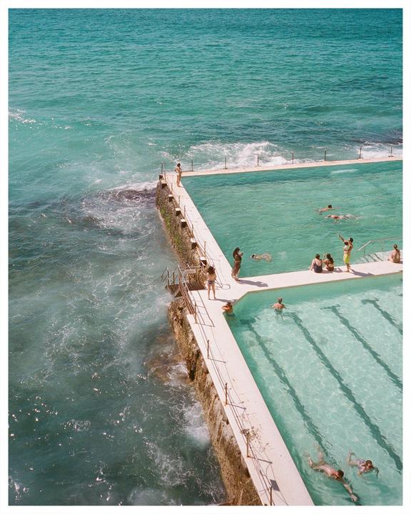 People swim in a pool next to the ocean at Bondi.