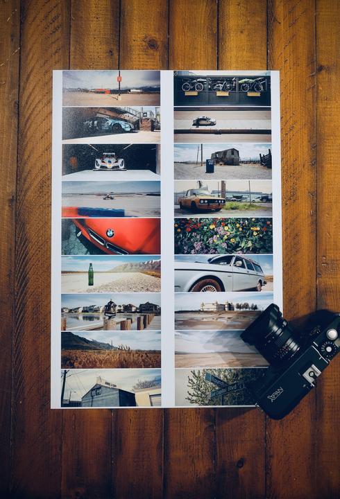 A contact sheet with 16 images is displayed on a wooden surface next to a camera.
