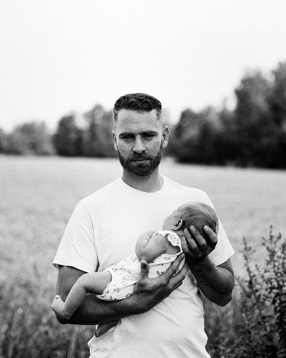 My brother and his first child–a miracle after a difficult year. Mamiya 645 with Cinestill Bwxx.