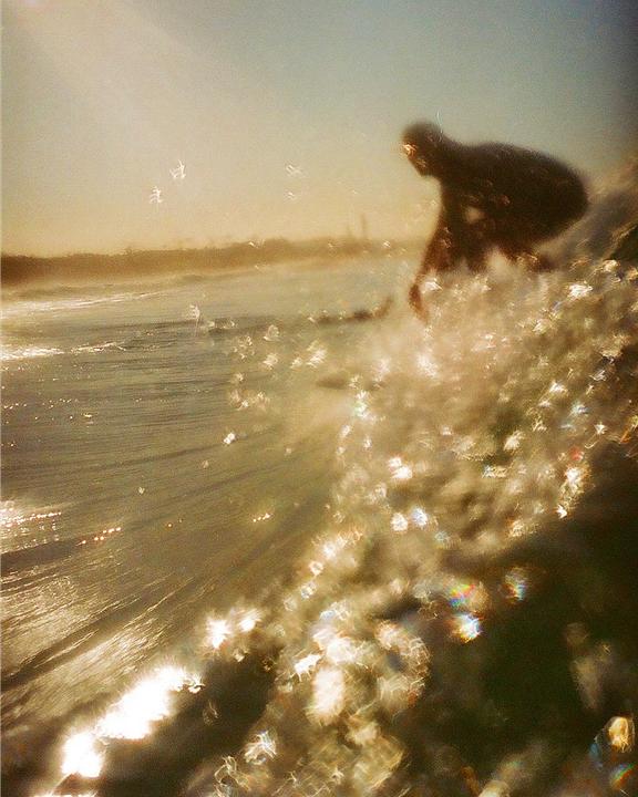 Golden surfer [expired Kodak gold 200, Nikonos IV, 35mm]