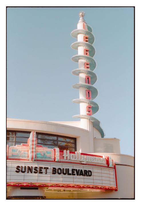 A tall, spiraling sign with neon letters spelling "LEGENDS" rises above a marquee that reads "SUNSET BOULEVARD."