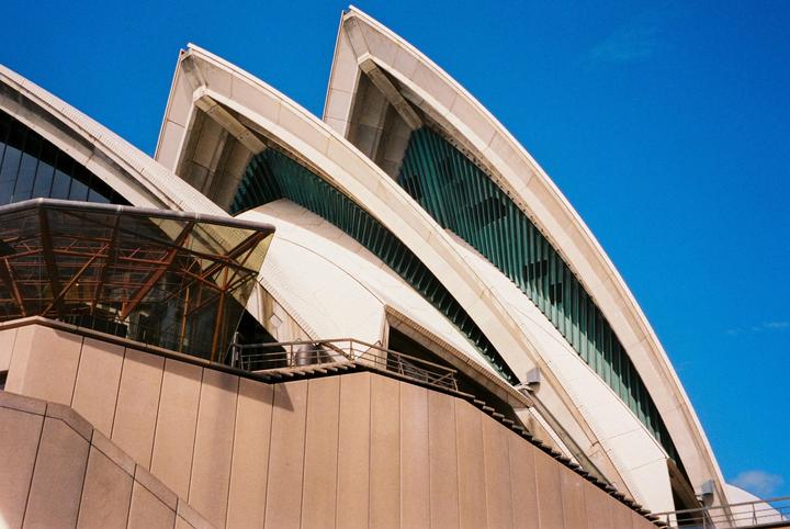 The Sydney Opera House is visible against a clear blue sky.