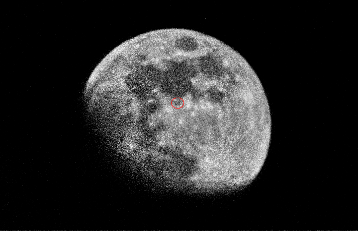 The moon is visible in the night sky with a red circle highlighting a small object.