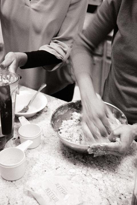 My wife helping her mother make Caribbean sweet bread [Ilford HP5 400, Canon 40mm f/2.8 STM, Canon EOS 630]