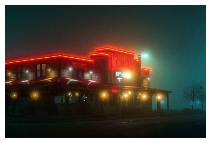 A restaurant with red neon lights and a sign that reads "Montana's BBQ & Bar" is visible at night.